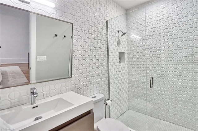 a bathroom with a sink toilet and shower