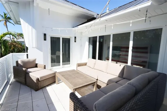 a outdoor space with patio couch and a potted plant