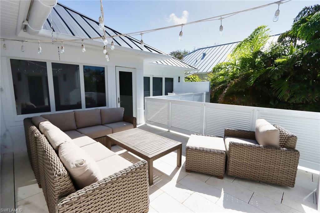 675 2nd Street South Naples, FL 34102 - Photo 25 of 31 a outdoor living space with furniture and a potted plant