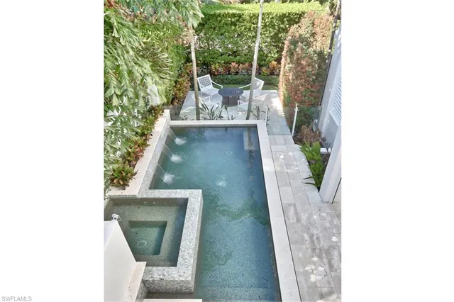 a view of a hallway with wooden floor and a potted plant