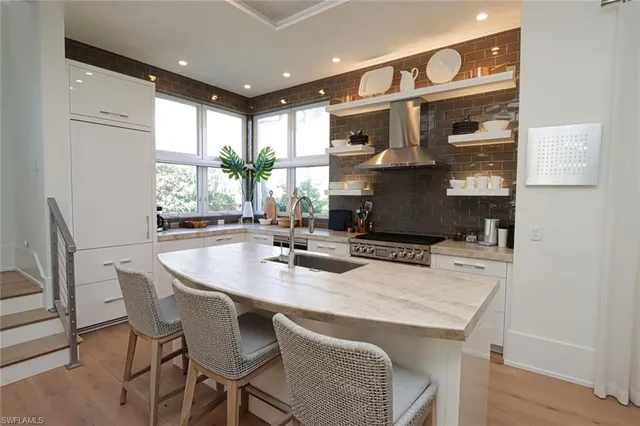 a kitchen with a table chairs stove and cabinets