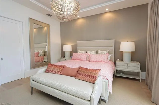 a bedroom with bed and a chandelier