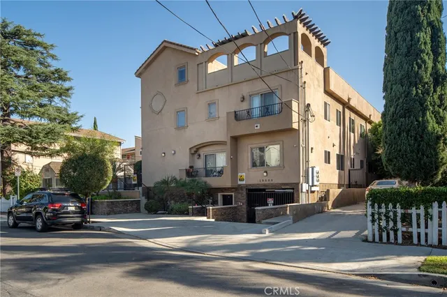 a view of a patio with couches and table and chairs and potted plants