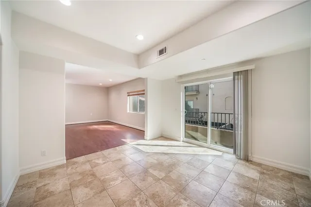 a view of an empty room with glass door
