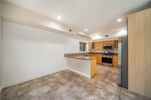a view of kitchen with cabinets