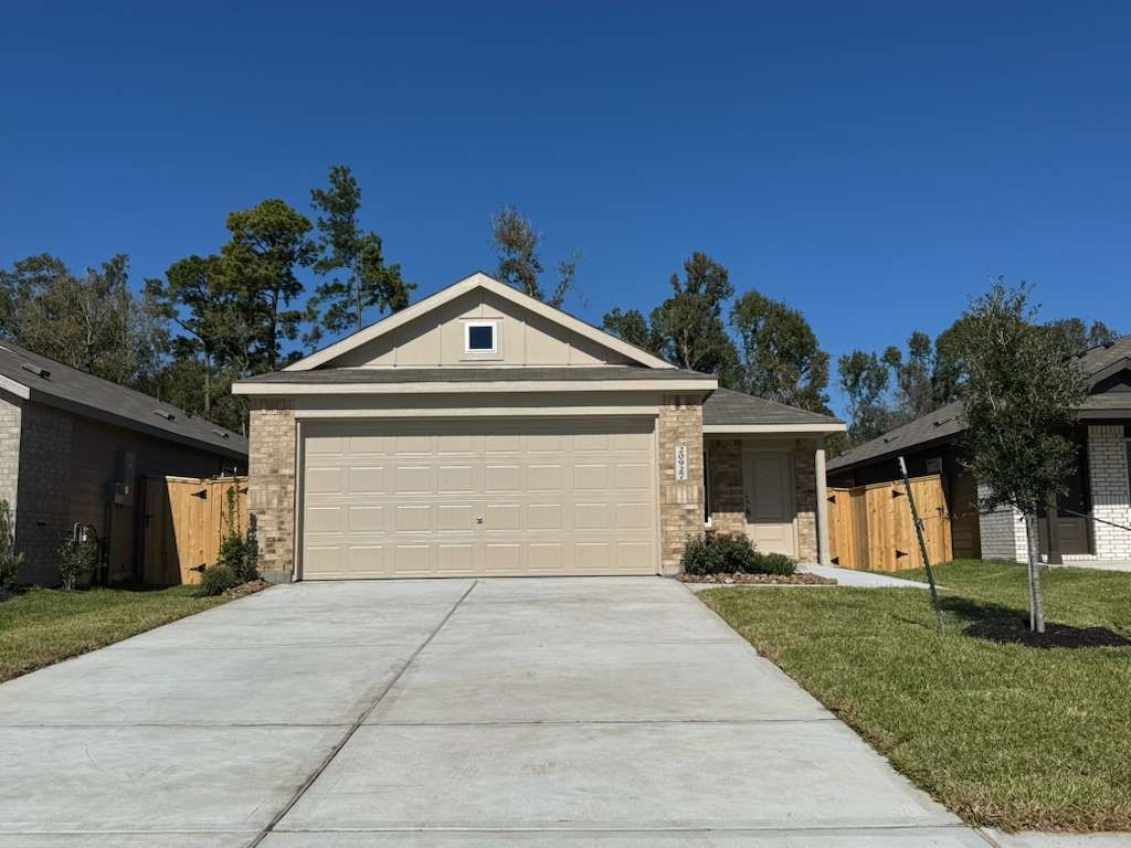 18015 Trepito Avenue New Caney, TX 77357 - Photo 14 of 14 a front view of a house with a yard and garage