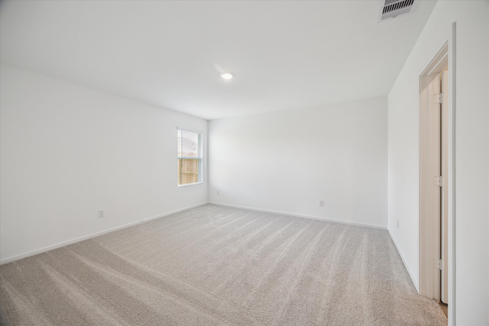 18015 Trepito Avenue New Caney, TX 77357 - Photo 6 of 14 a view of an empty room and a window