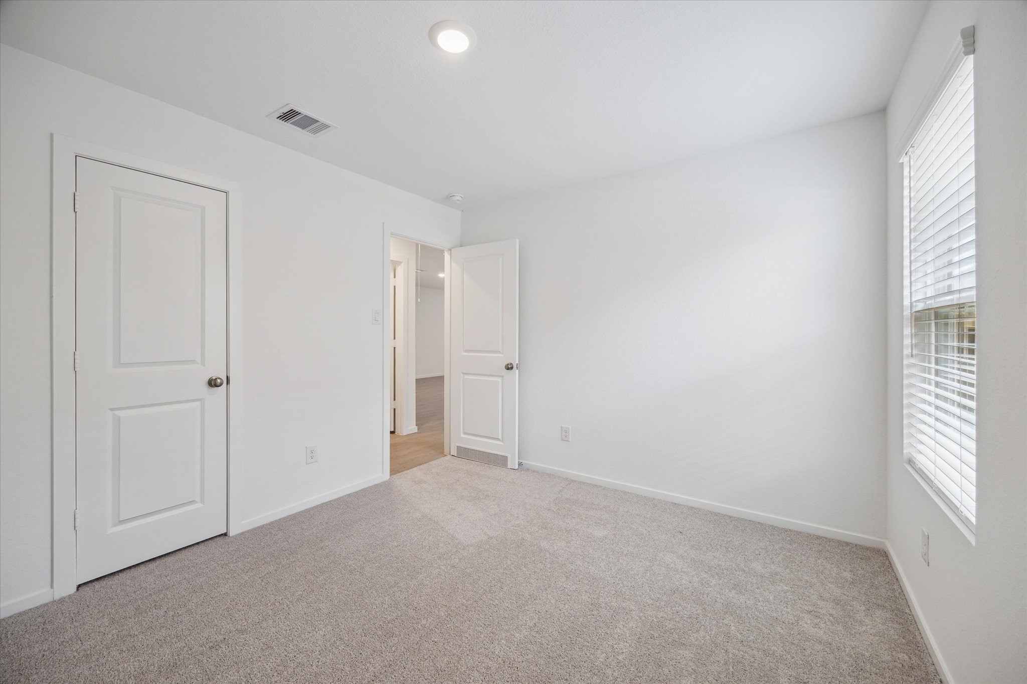 18015 Trepito Avenue New Caney, TX 77357 - Photo 10 of 14 a view of an empty room and a window