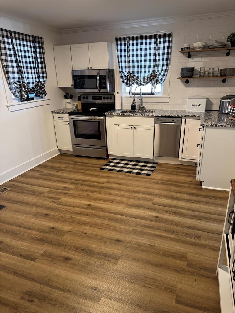 4367 Old Macon Road Columbus, GA 31907 - Photo 23 of 32 a kitchen with stainless steel appliances granite countertop a stove a sink and a microwave