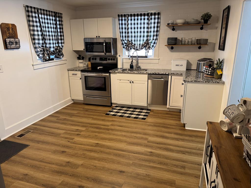 4367 Old Macon Road Columbus, GA 31907 - Photo 24 of 32 a kitchen with stainless steel appliances granite countertop a stove a sink and a microwave