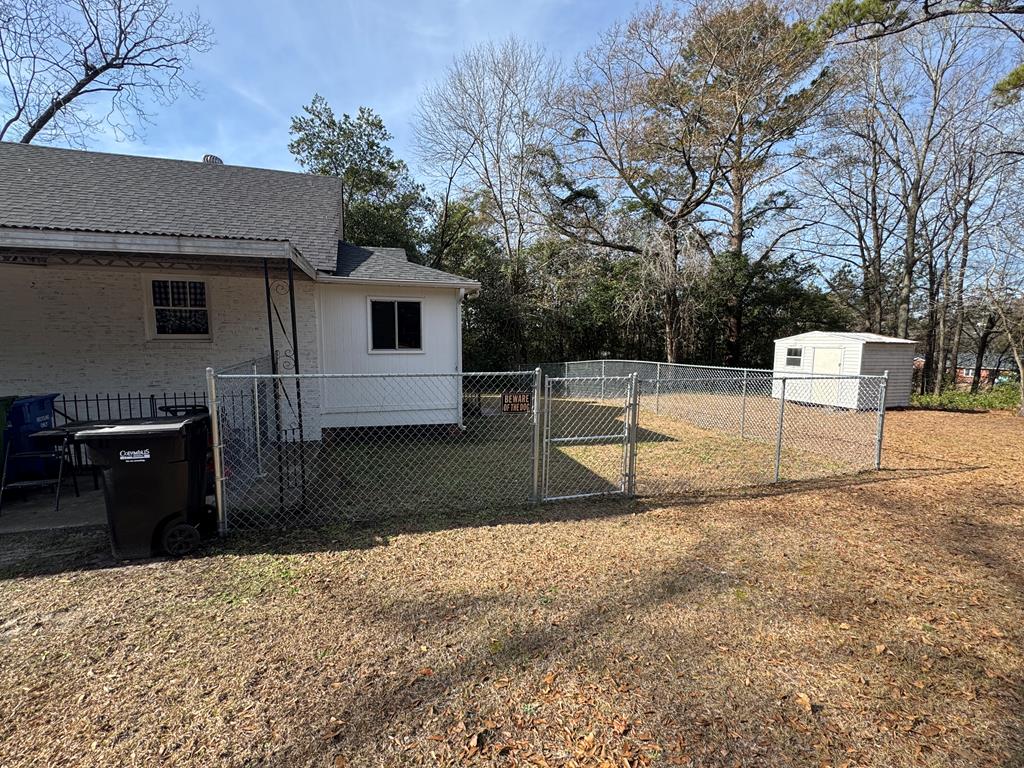 4367 Old Macon Road Columbus, GA 31907 - Photo 9 of 32 a view of backyard with wooden fence and a large tree