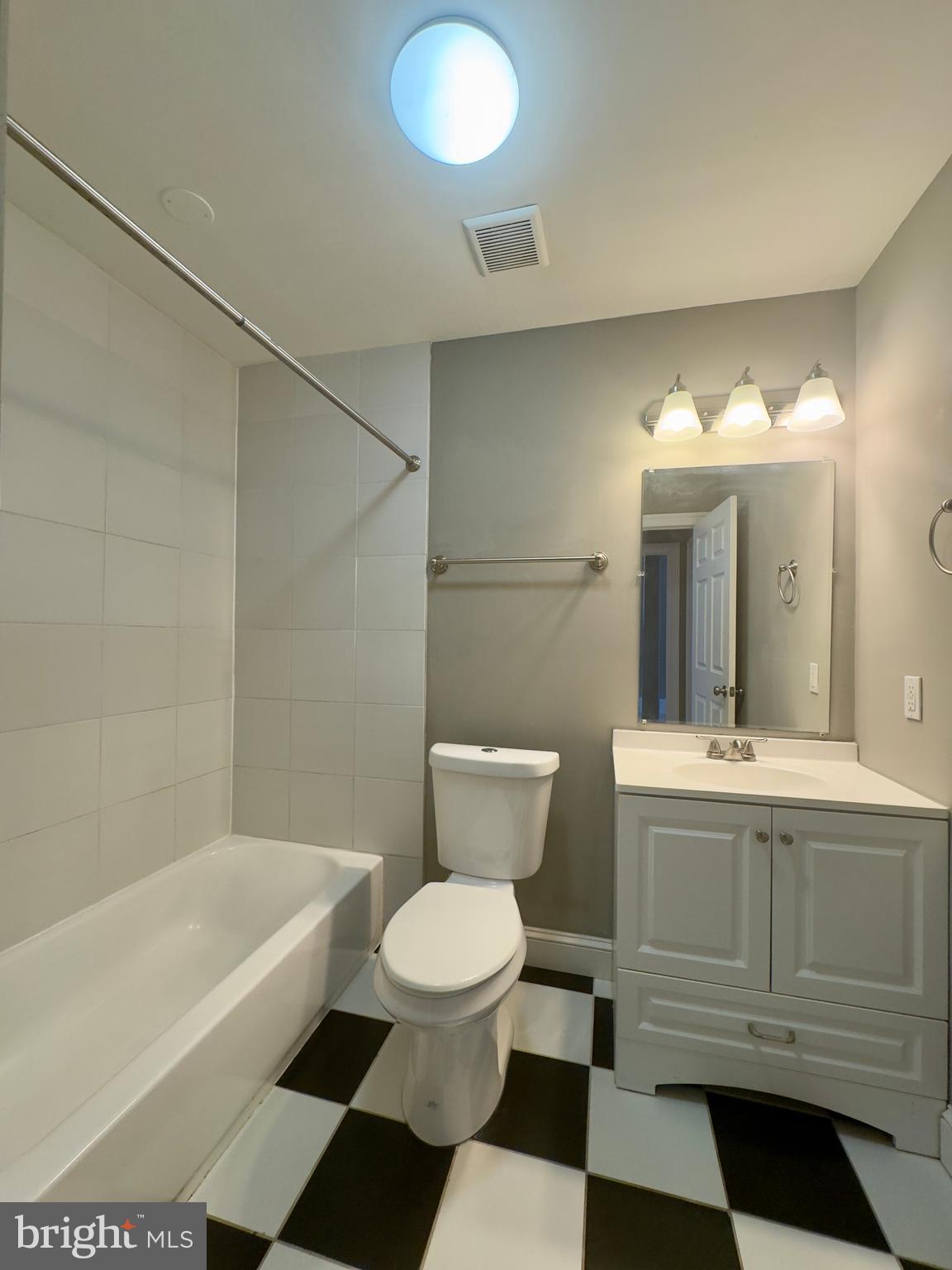 7 West Mulberry Street, Unit 7 Baltimore, MD 21201 - Photo 14 of 16 a bathroom with a sink a toilet a mirror and bathtub