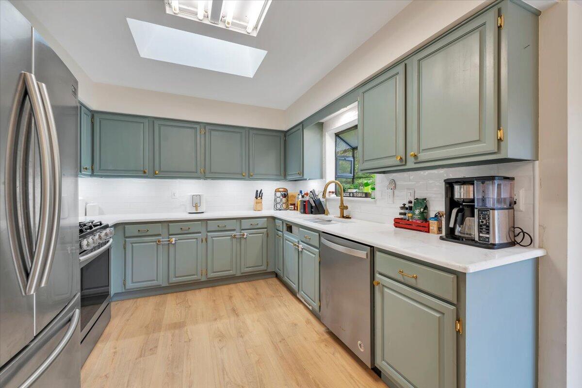 7851 Cedar Edge Road Roanoke, VA 24018 - Photo 11 of 44 a kitchen with a sink cabinets and stainless steel appliances
