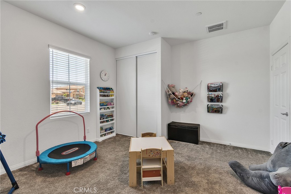 402 Appleton Way Perris, CA 92570 - Photo 14 of 34 a living room with furniture and gym equipment