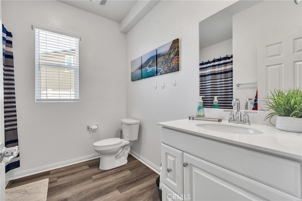 402 Appleton Way Perris, CA 92570 - Photo 15 of 34 a bathroom with a sink toilet and a window