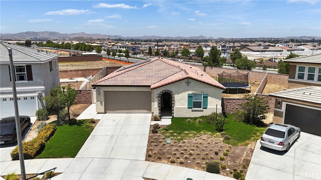 402 Appleton Way Perris, CA 92570 - Photo 2 of 34 an aerial view of a house with a yard