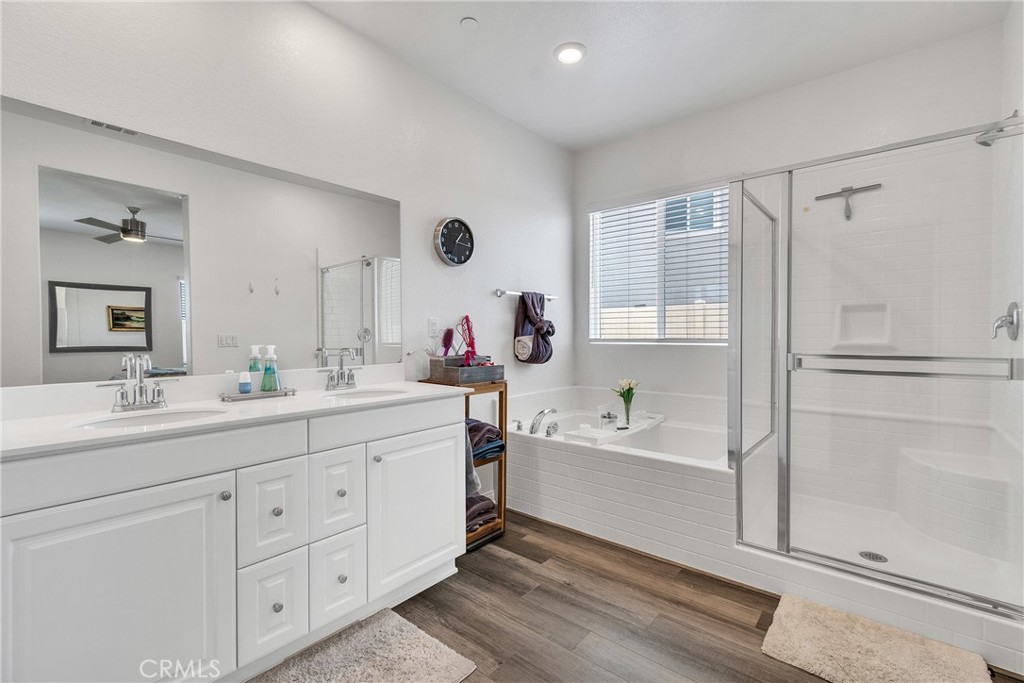 402 Appleton Way Perris, CA 92570 - Photo 23 of 34 a spacious bathroom with a double vanity sink a mirror and a bathtub