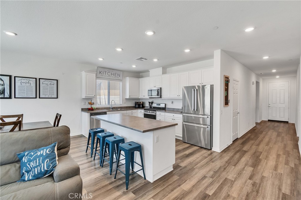 402 Appleton Way Perris, CA 92570 - Photo 26 of 34 a kitchen with stainless steel appliances granite countertop a refrigerator and a stove top oven