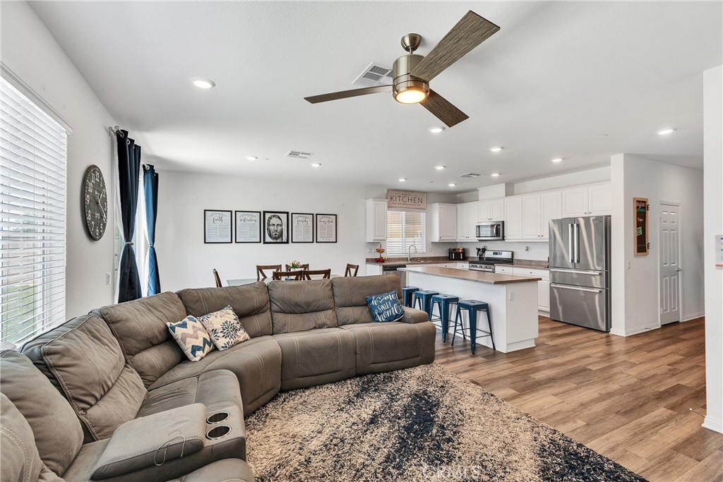 402 Appleton Way Perris, CA 92570 - Photo 27 of 34 a living room with furniture and kitchen view