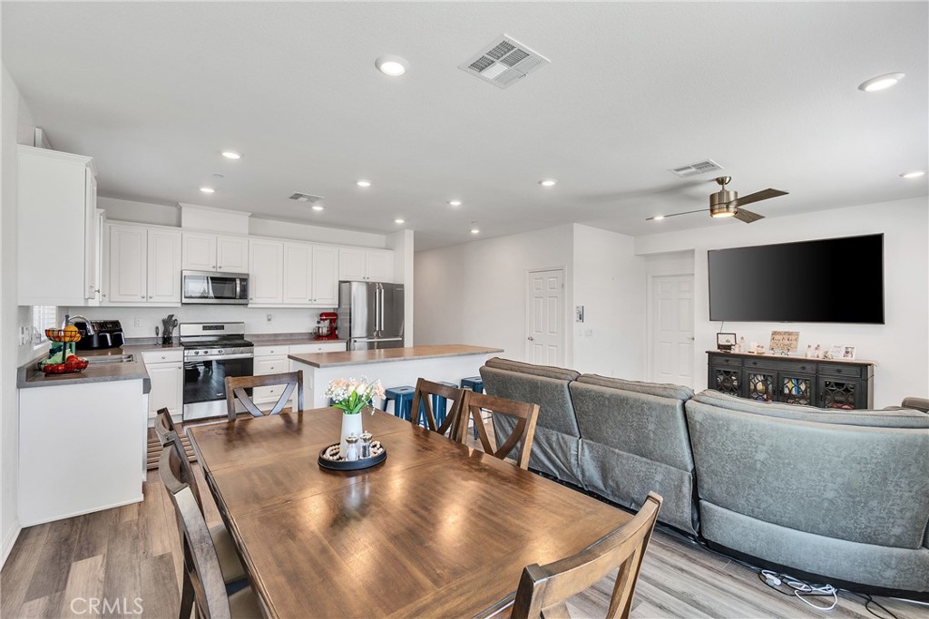 402 Appleton Way Perris, CA 92570 - Photo 31 of 34 a living room with stainless steel appliances furniture and a flat screen tv