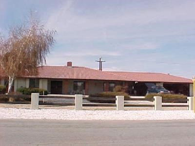 19311 Oneida Road Apple Valley, CA 92307 - Photo 1 of 1 a front view of a house with a yard