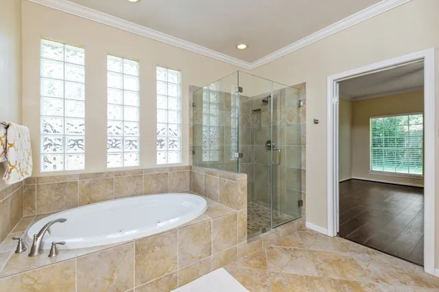 a bathroom with a granite countertop tub shower and sink