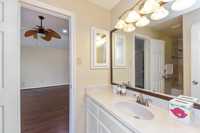a bathroom with a sink a mirror and a light fixture