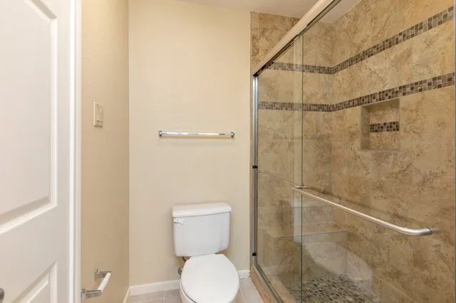 a white toilet sitting next to a bathroom sink