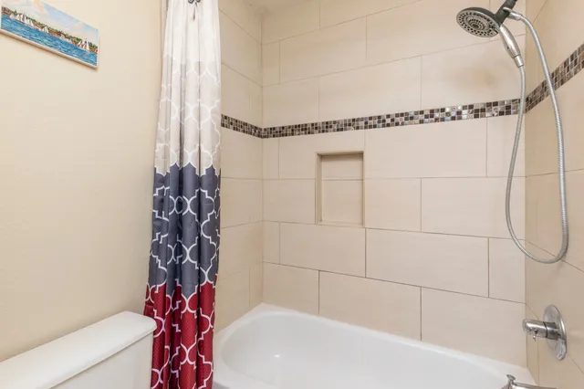 a bathroom with a bathtub and shower