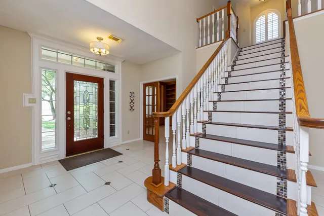 a view of an entryway with wooden floor and windows