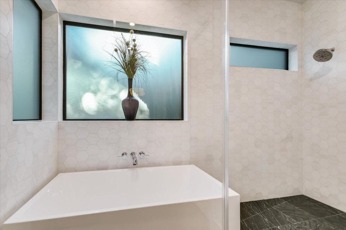 403 Ridgewood Road Austin, TX 78746 - Photo 24 of 34 a bathroom with a bathtub and a shower