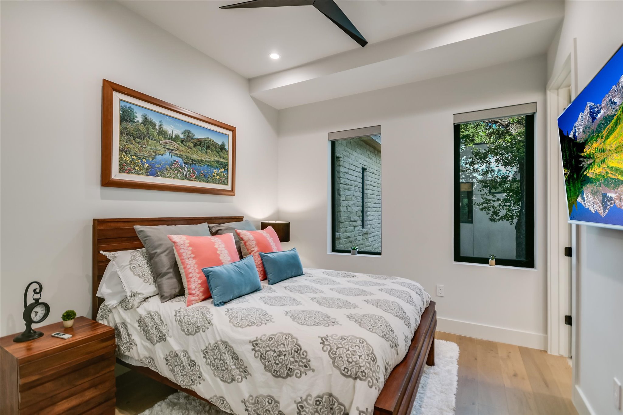 403 Ridgewood Road Austin, TX 78746 - Photo 27 of 34 a bedroom with a bed and a painting on the wall