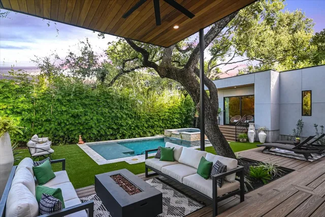 a view of a patio with couches table and chairs and potted plants