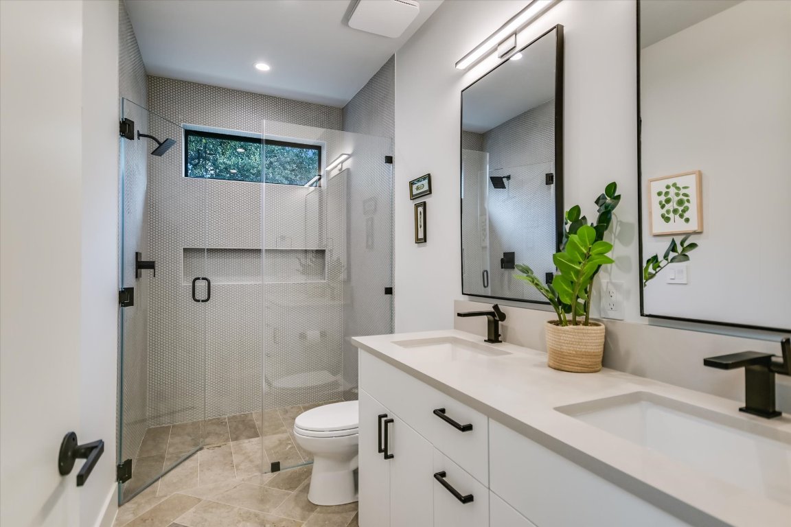 403 Ridgewood Road Austin, TX 78746 - Photo 28 of 34 a bathroom with a sink a toilet and shower