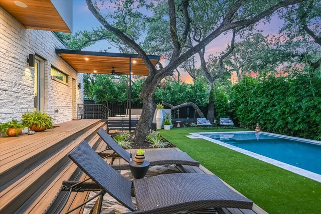 a backyard of a house with table and chairs