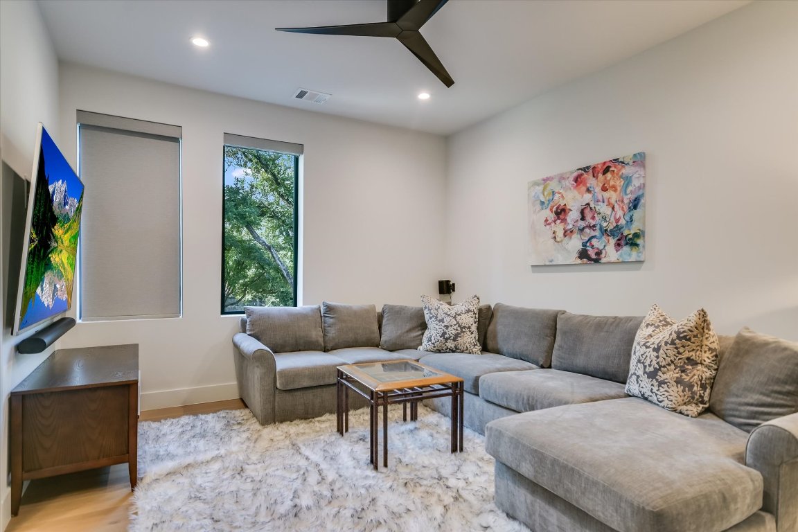 403 Ridgewood Road Austin, TX 78746 - Photo 30 of 34 a living room with furniture and a flat screen tv