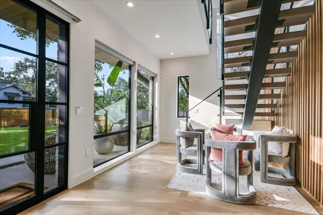 a dining room with furniture and large window