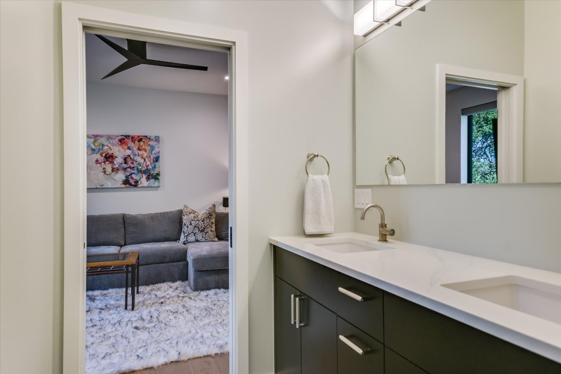 403 Ridgewood Road Austin, TX 78746 - Photo 31 of 34 a en suite bathroom with a sink and a mirror