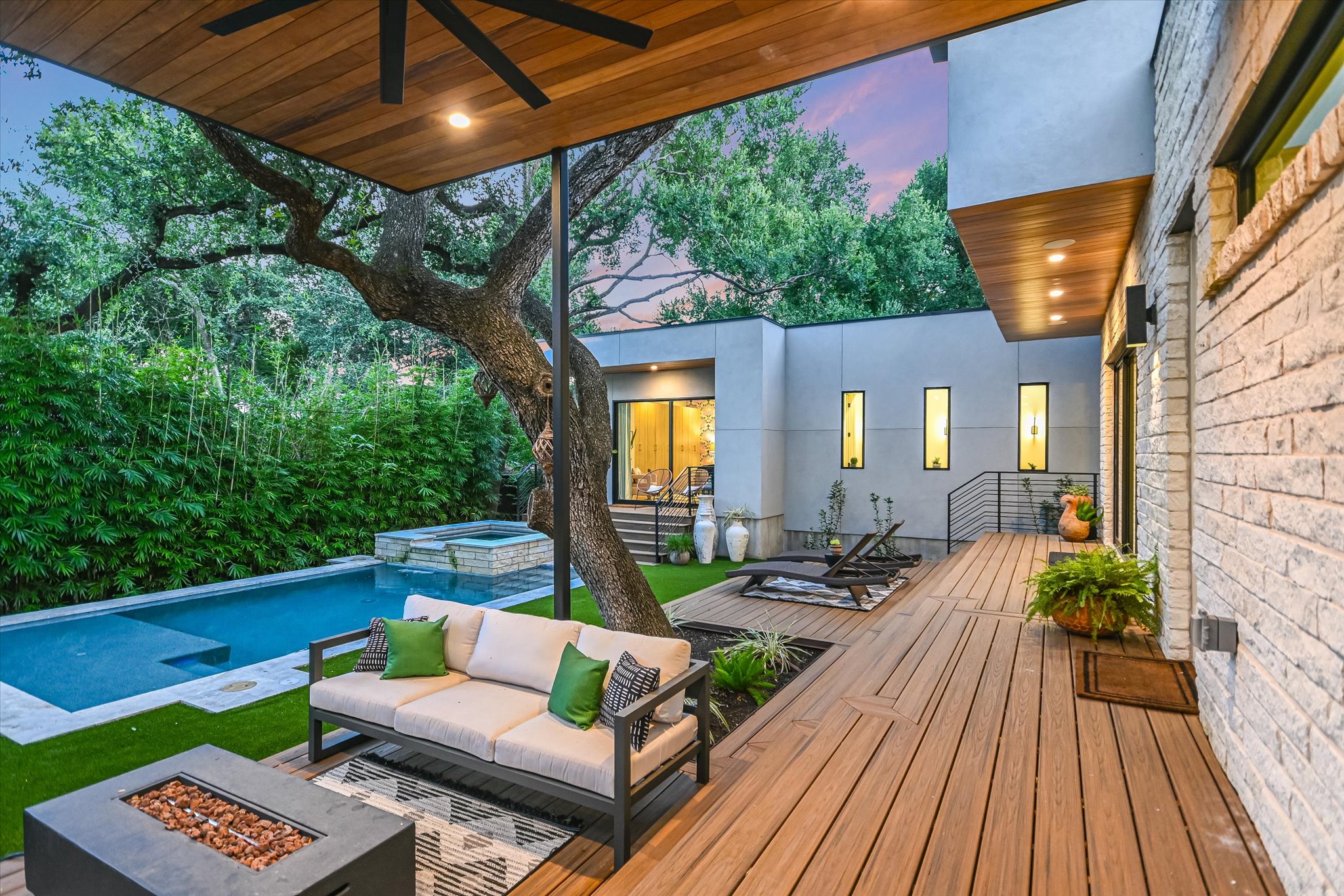 403 Ridgewood Road Austin, TX 78746 - Photo 33 of 34 a view of a patio with couches table and chairs with wooden floor and fence