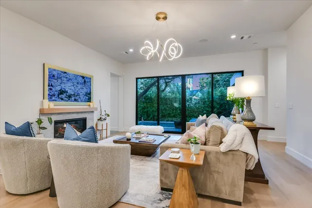 a living room with furniture a fireplace and a large window