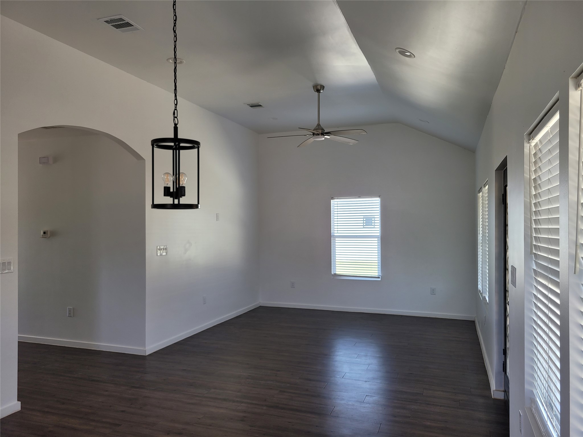 422 County Road 422 Road Stockdale, TX 78160 - Photo 9 of 37 An airy living space features a vaulted ceiling, wood-look flooring, and natural illumination from wide windows.