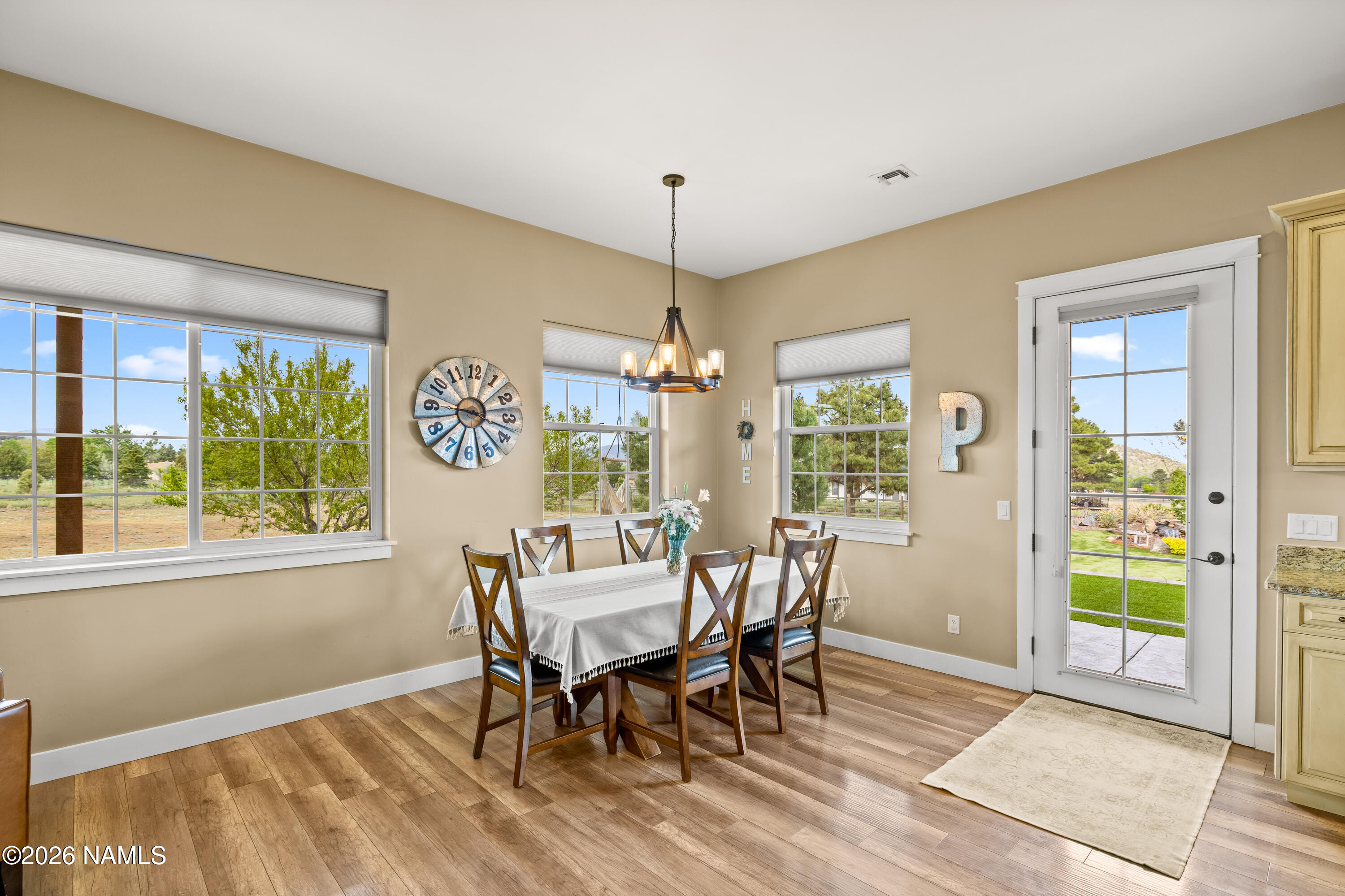 10833 Sage Road Flagstaff, AZ 86004 - Photo 15 of 45 a dining room with furniture a chandelier and wooden floor