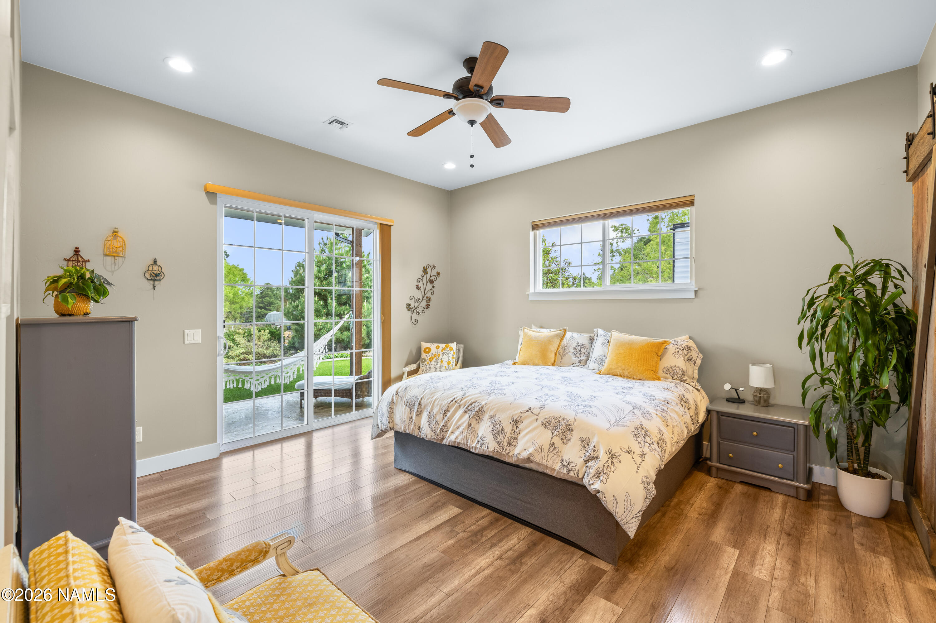 10833 Sage Road Flagstaff, AZ 86004 - Photo 18 of 45 a spacious bedroom with a bed and a window