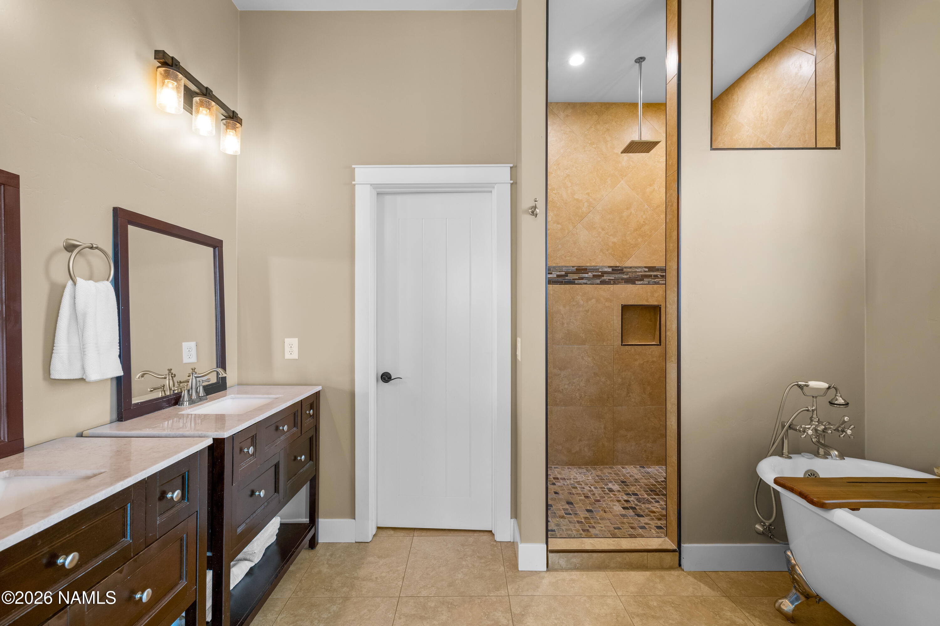 10833 Sage Road Flagstaff, AZ 86004 - Photo 21 of 45 a spacious bathroom with a double vanity sink a mirror and a shower