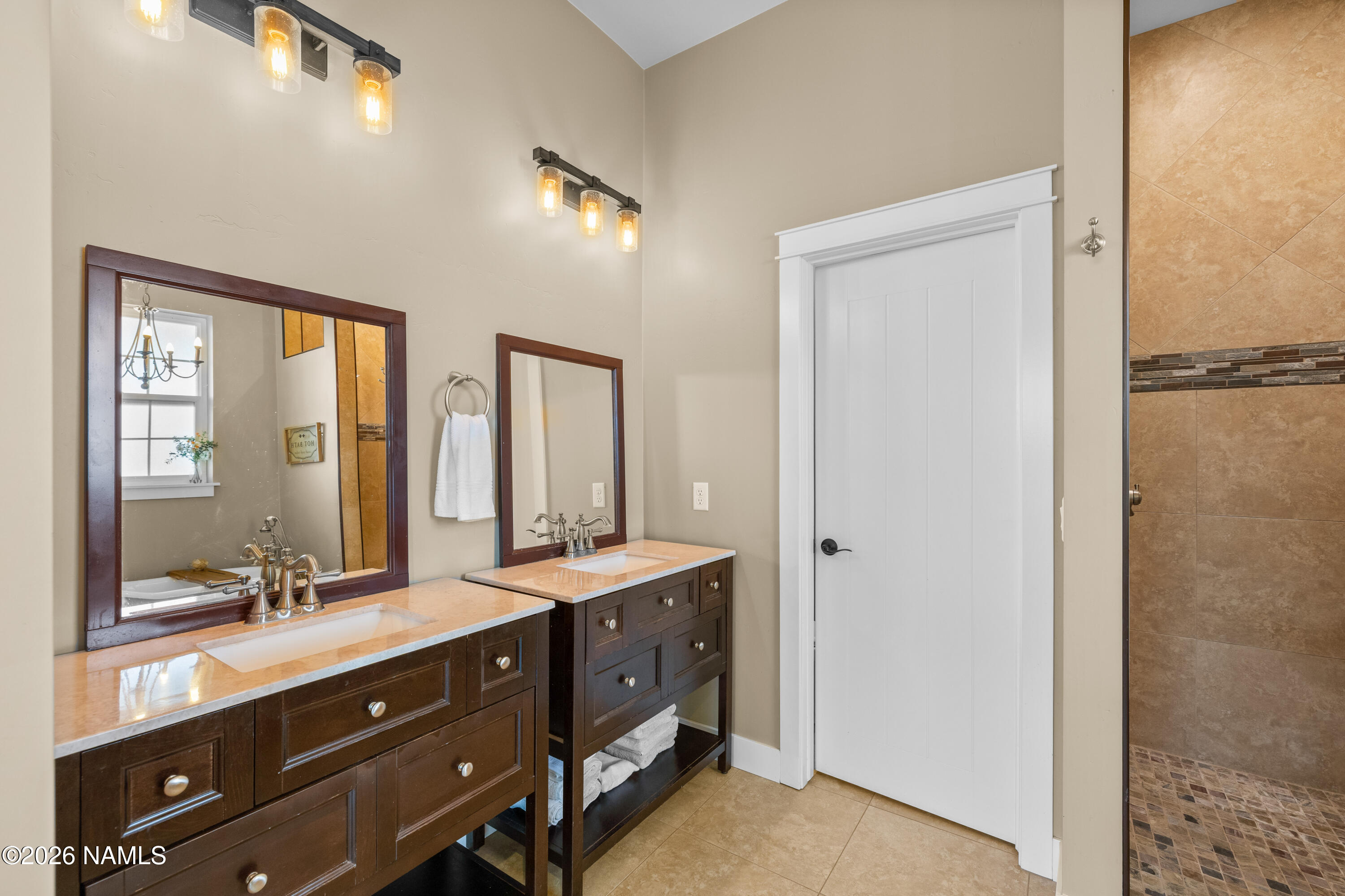 10833 Sage Road Flagstaff, AZ 86004 - Photo 23 of 45 a bathroom with a double vanity sink and a mirror