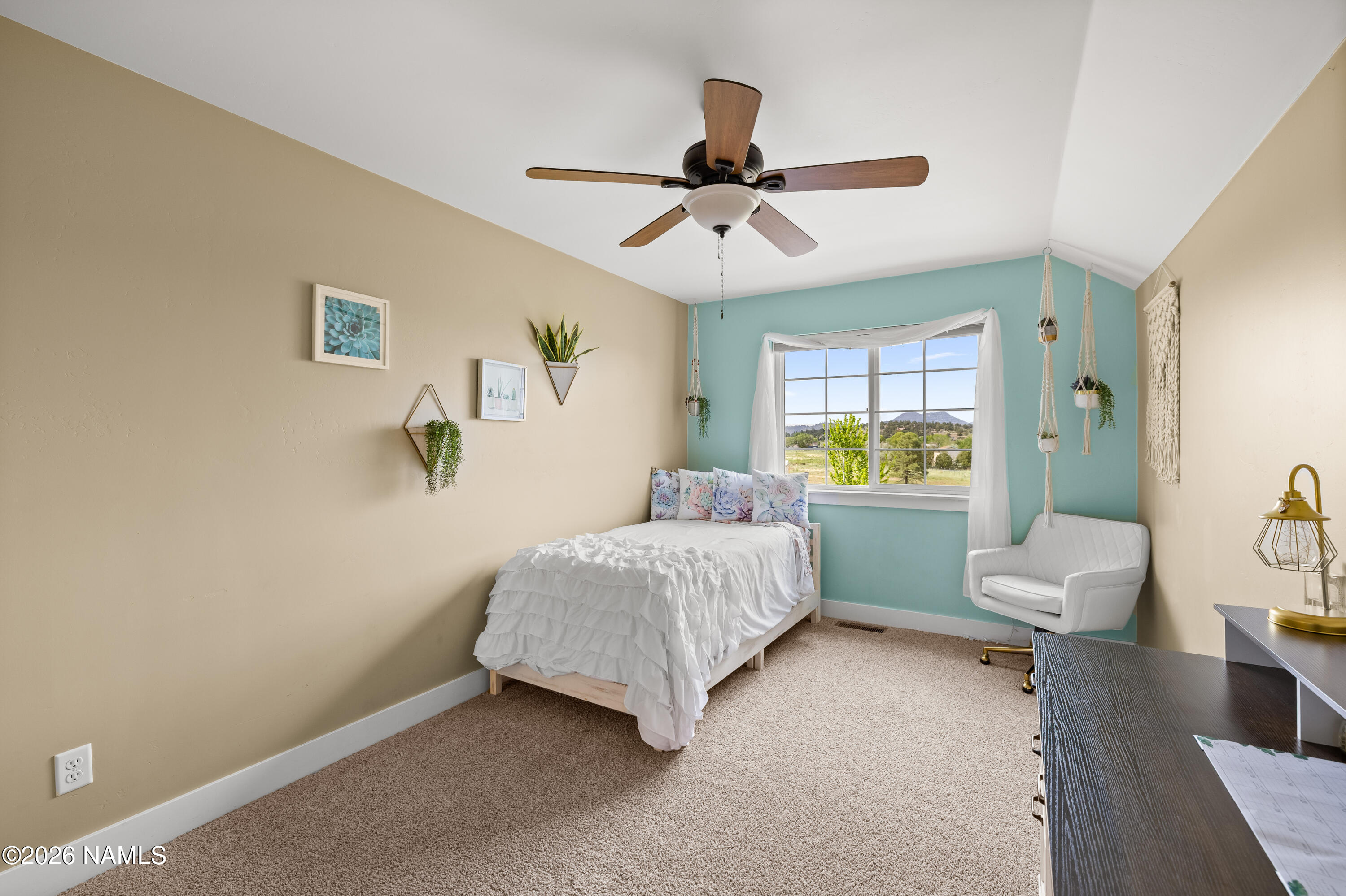10833 Sage Road Flagstaff, AZ 86004 - Photo 26 of 45 a bedroom with a bed and a chandelier
