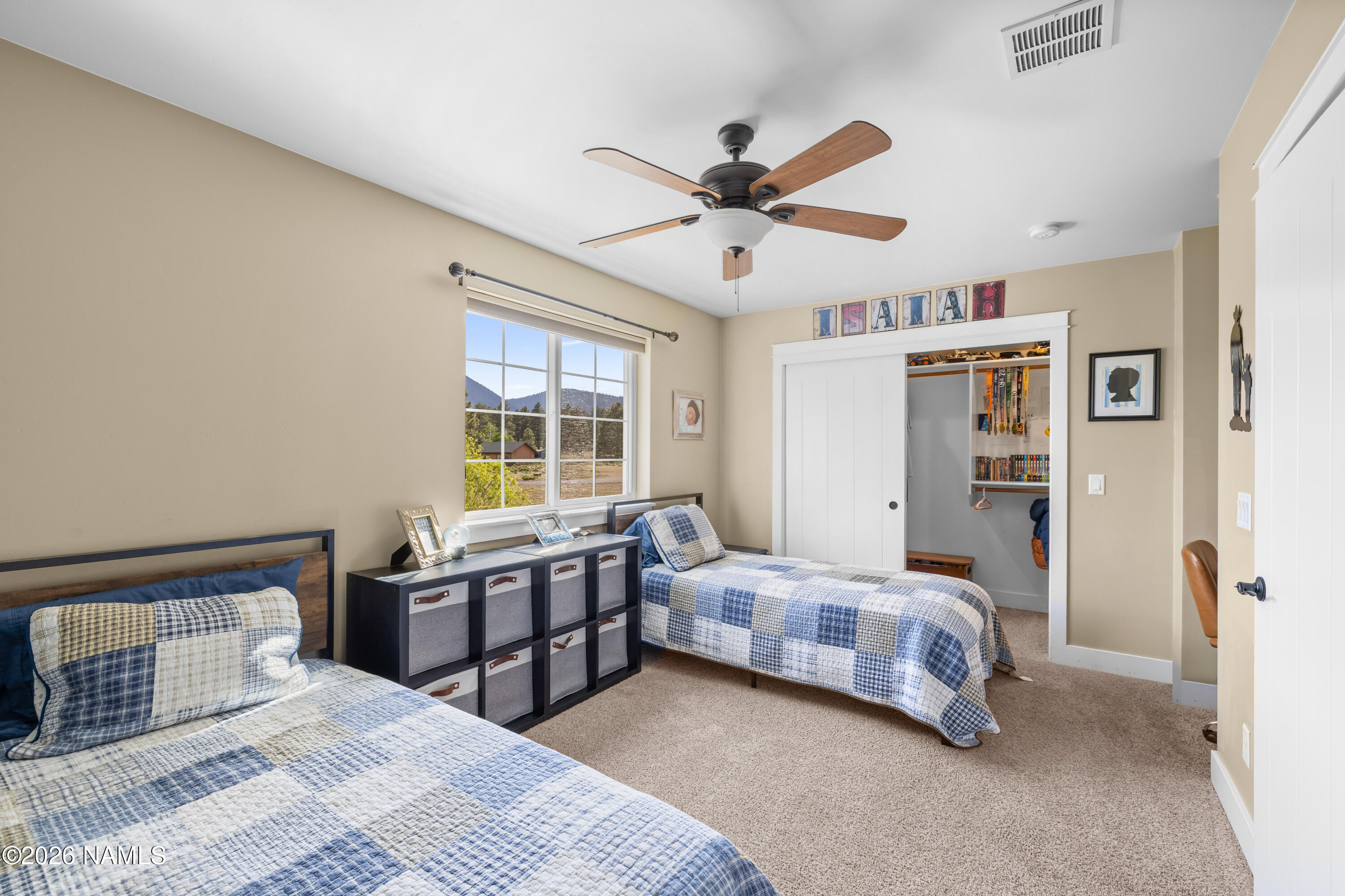 10833 Sage Road Flagstaff, AZ 86004 - Photo 28 of 45 a bedroom with a bed and a large window