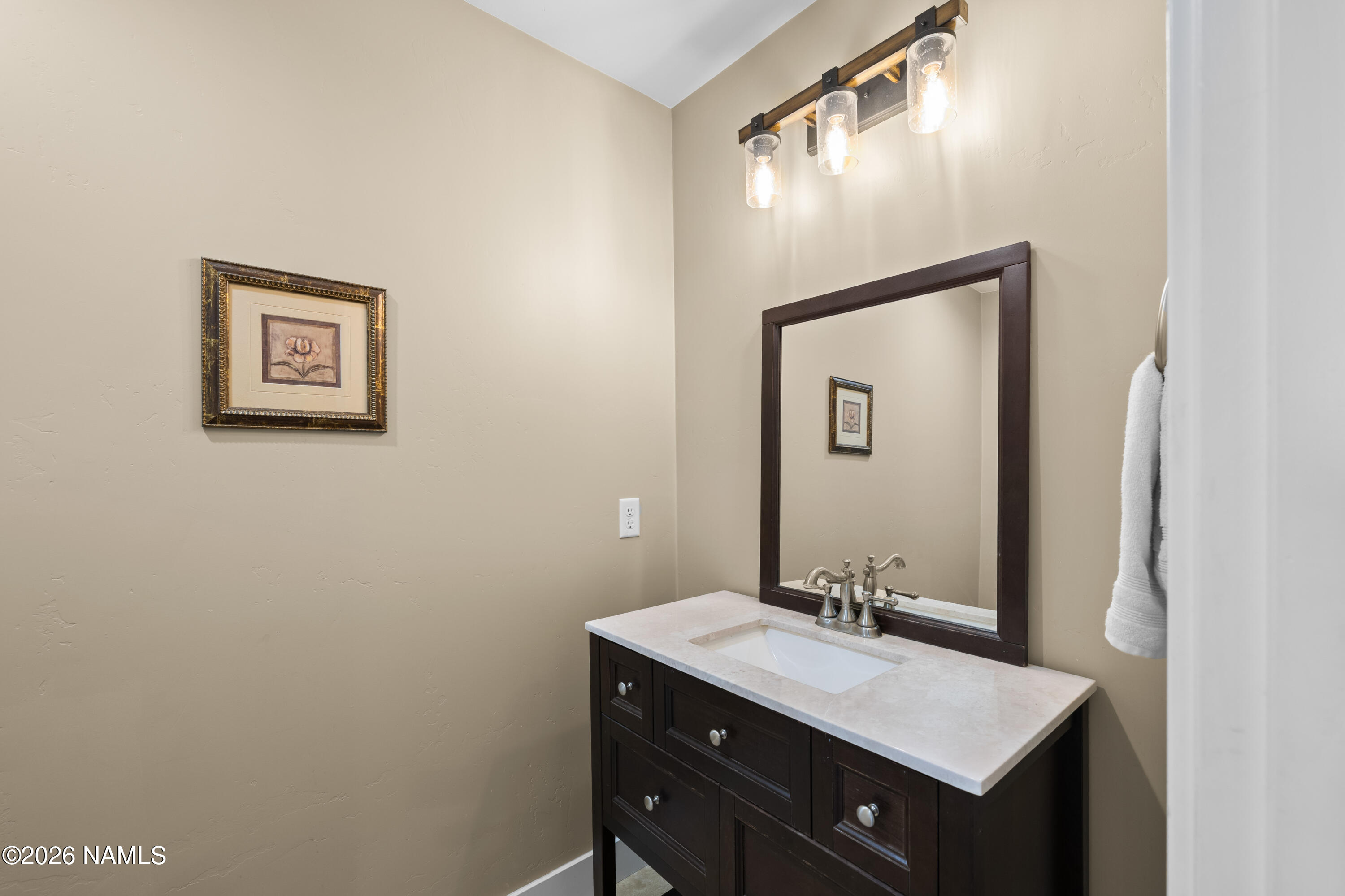 10833 Sage Road Flagstaff, AZ 86004 - Photo 30 of 45 a bathroom with a sink vanity and mirror