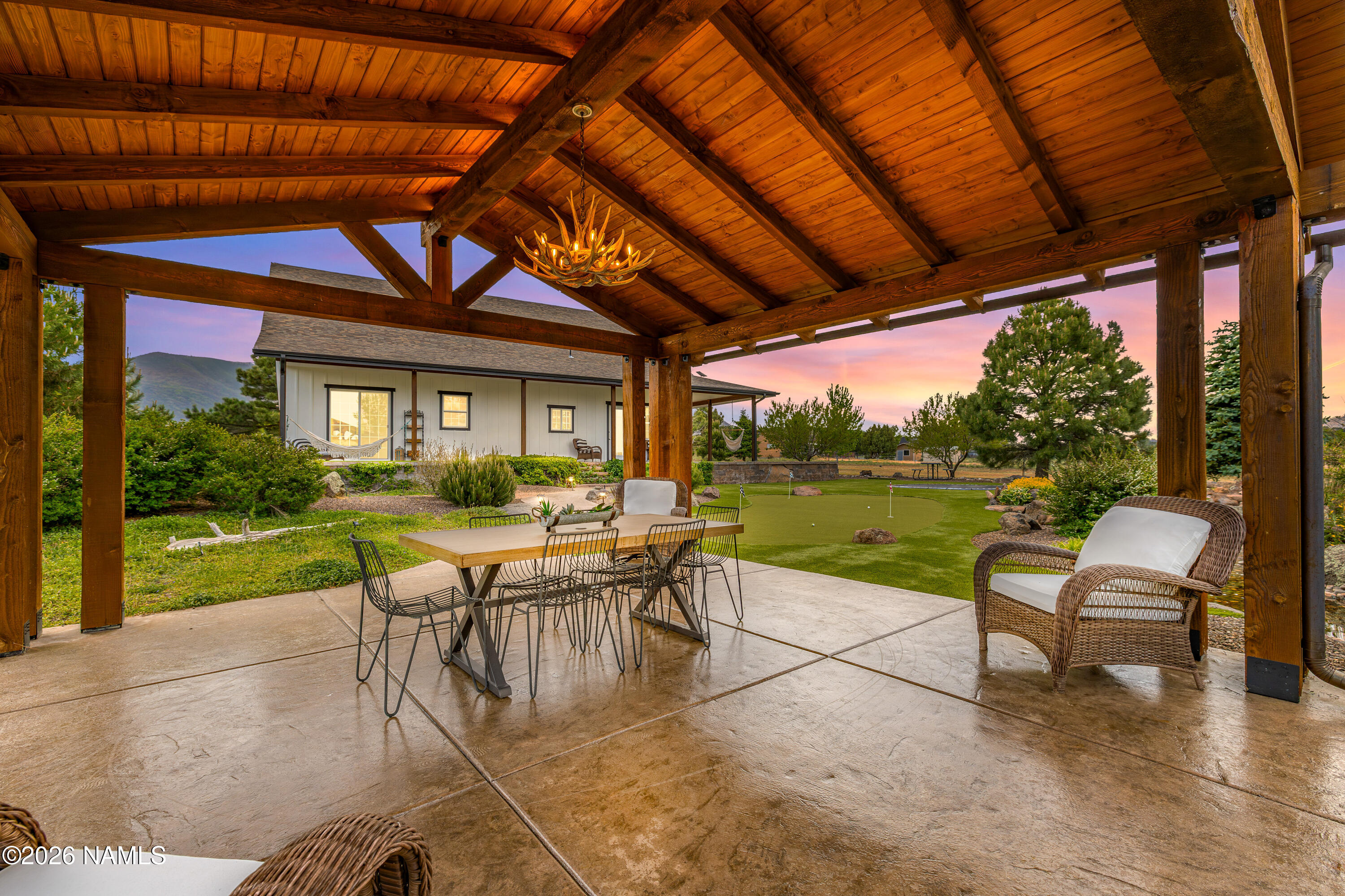 10833 Sage Road Flagstaff, AZ 86004 - Photo 33 of 45 a patio with yard glass top table and chairs