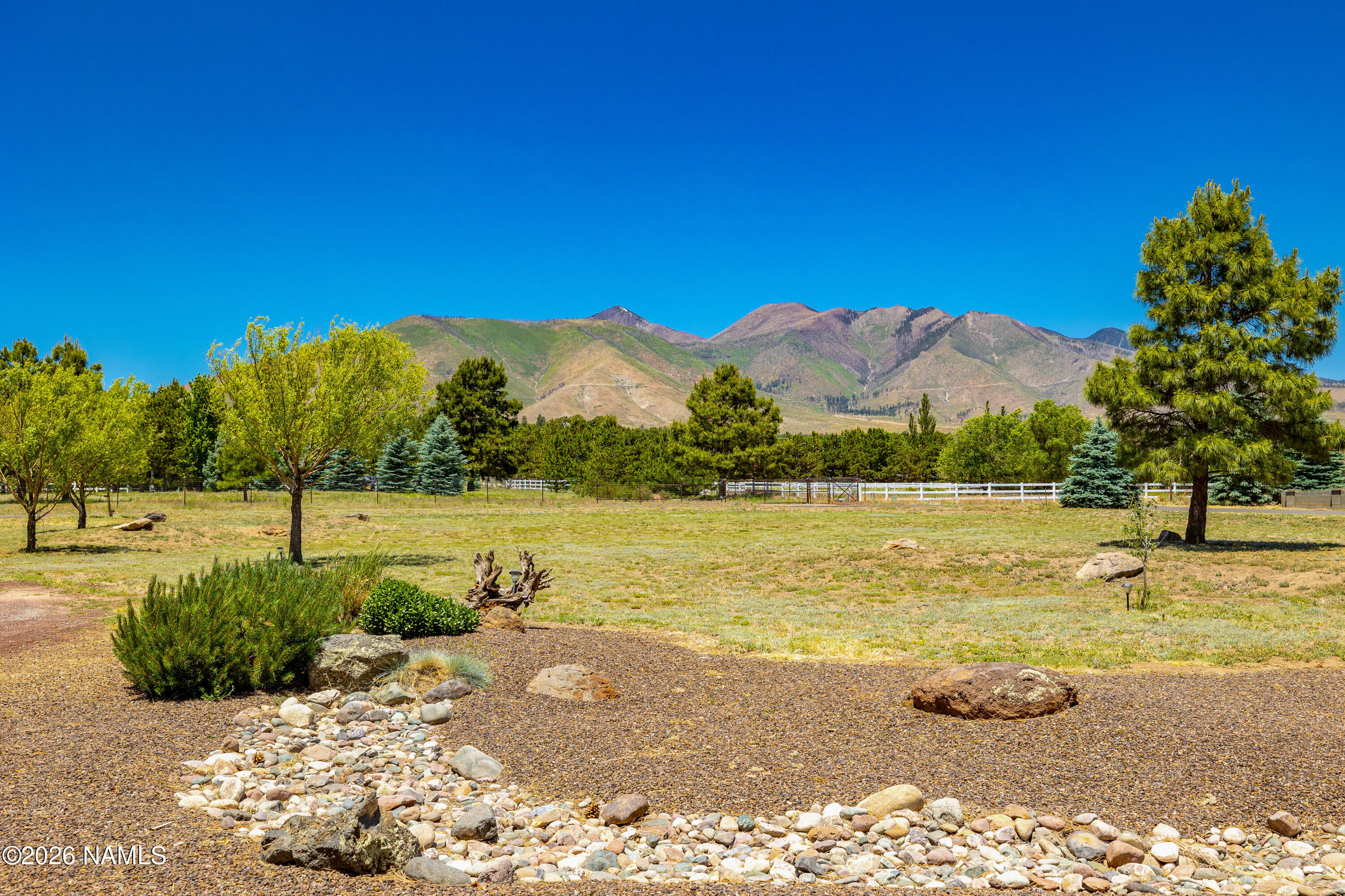 10833 Sage Road Flagstaff, AZ 86004 - Photo 37 of 45 a view of a lake with a mountain in the background